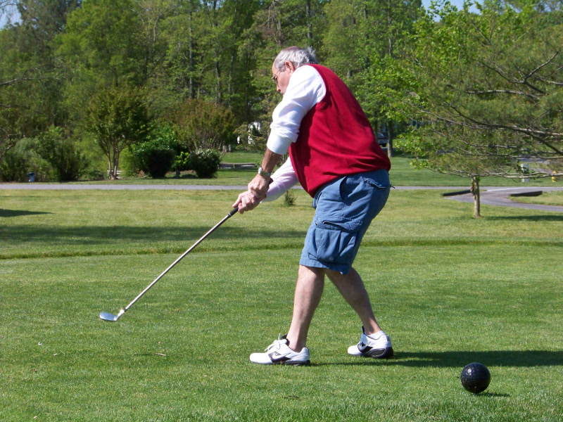 Man Swinging Golf Club